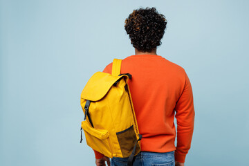 Back rear view of young teen boy student wearing orange sweatshirt casual clothes backpack bag...
