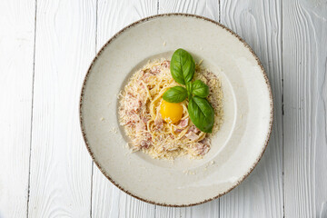 delicious pasta in a plate on a white wooden table. close-up
