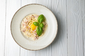 delicious pasta in a plate on a white wooden table. close-up
