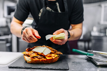 chef hand cooking big large cheese burger on restaurant kitchen. step by step