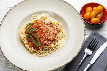 delicious pasta in a plate on a white wooden table. close-up
