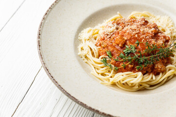 delicious pasta in a plate on a white wooden table. close-up
