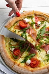 delicious pizza on a white wooden table. close-up

