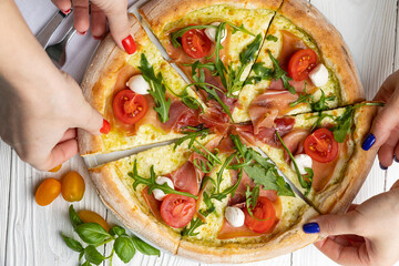 delicious pizza on a white wooden table. close-up
