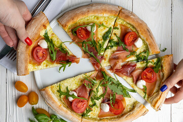 delicious pizza on a white wooden table. close-up
