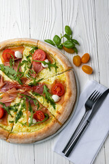 delicious pizza on a white wooden table. close-up
