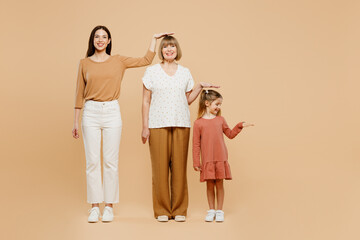 Full body smiling women wearing casual clothes with child kid girl 6-7 years old. Granny mother...