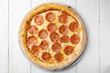 delicious pizza on a white wooden table. close-up
