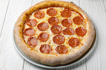 delicious pizza on a white wooden table. close-up
