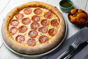 delicious pizza on a white wooden table. close-up
