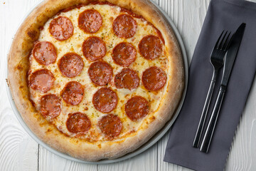 delicious pizza on a white wooden table. close-up
