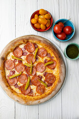delicious pizza on a white wooden table. close-up
