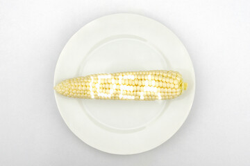 Corn with glowing idea text on a white plate.