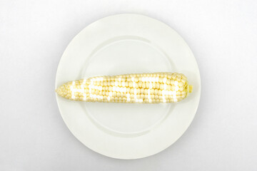 Corn with glowing health text on a white plate.