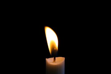 candle flame close up on dark background Melted wax candles that burn at night white candle burning in the dark candlelight