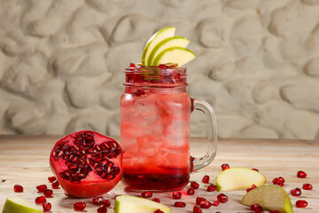 Arabic Style fresh pomegranate mojito with Pear fruit juices served in jar isolated on background...