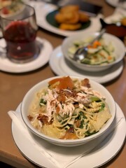 Mie Godog Jawa. Popular Javanese comfort food of yellow noodles with chicken, meatballs, vegetables and duck egg in chicken broth. Accompanied with cucumber pickles and green chili peppers.