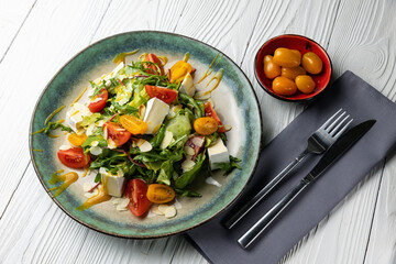 delicious salad on a white wooden table. close-up