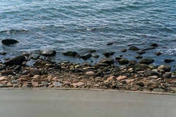 Below the road above the sea.