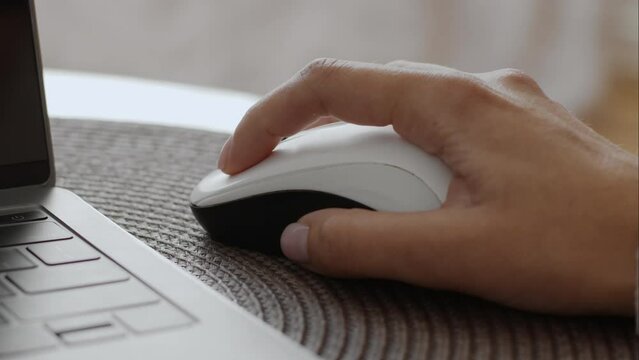 Close up shot of female hand using wireless computer mouse, unrecognizable woman making online research on laptop Generative AI