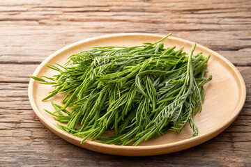 young leaves,Leucaena leucocepphala,Thai local vegetables,food High in phosphorus on wooden plate.