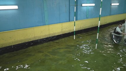 caucasian rowing on a black kayak. training in the pool. slow motion video. kayak slalom. High quality Full HD video recording Generative AI - Powered by Adobe