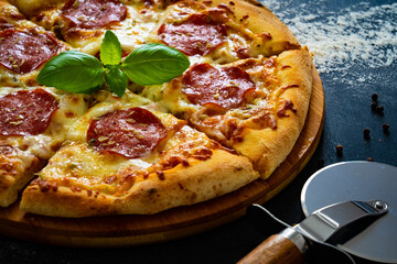 Circle pepperoni pizza with mozzarella cheese on wooden table
