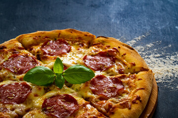 Circle pepperoni pizza with mozzarella cheese on wooden table
