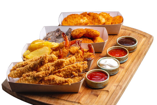 four boxes of nuggets with chicken prawn cheese and fish with four sauce png image _ fast food image _ Indian food image _ nuggets in isolated white back ground 