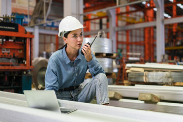 The project manager and engineers are inspecting workpieces and checking standards and safety for products and safety in the factory. Technician and Female Worker Talking on a Meeting in a Factory.