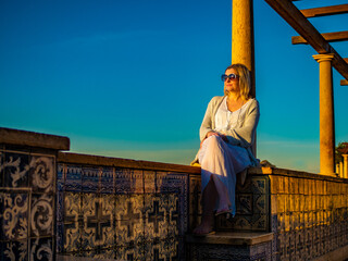 Woman sitting at Santa Luzia viewpoint in Lisbon
 - obrazy, fototapety, plakaty