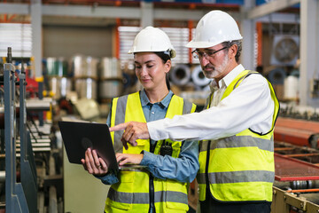 The project manager and engineers are inspecting workpieces and checking standards and safety for products and safety in the factory. Technician and Female Worker Talking on a Meeting in a Factory.