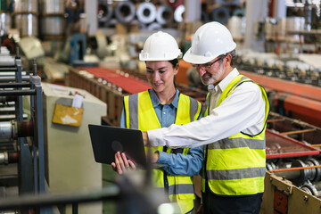 The project manager and engineers are inspecting workpieces and checking standards and safety for products and safety in the factory. Technician and Female Worker Talking on a Meeting in a Factory.