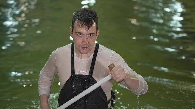 man in the pool with a paddle in his hands. close-up face. slalom kayaking. slow motion video. High quality Full HD video recording Generative AI