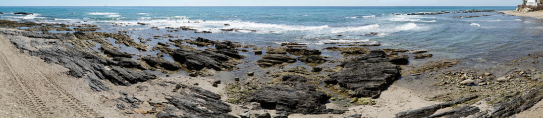 Rocks on sea shore in Cala de Mijas, Spain - panorama