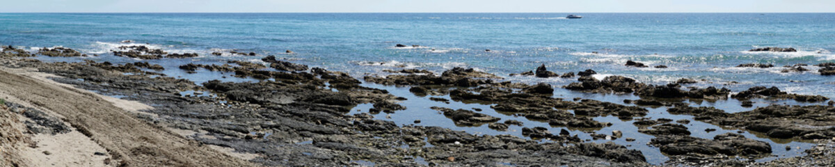 Rocks on sea shore in Cala de Mijas, Spain - panorama