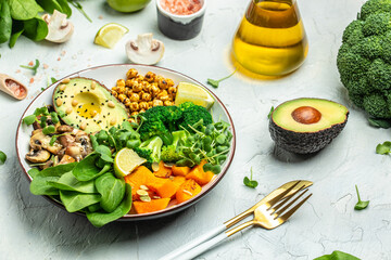 vegetable vegetarian buddha bowl avocado, mushrooms, broccoli, spinach, chickpeas, pumpkin on a light background. top view - obrazy, fototapety, plakaty
