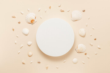 Fototapeta na wymiar Product podium with seashells on warm beige background top view, flat lay. Summer display for product presentation
