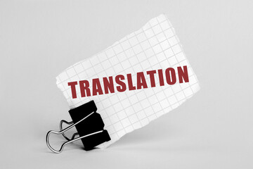 Piece of paper on a grey background with text Translation