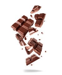 Broken bar of dark chocolate in the air on a white background