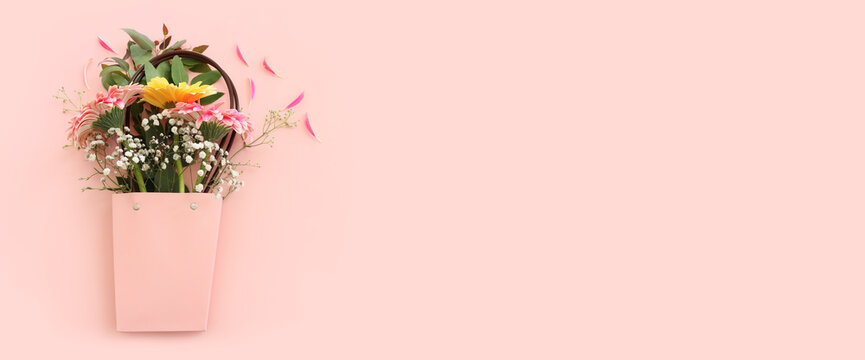 Top view image of beautiful flowers composition over pastel pink background