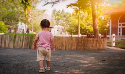 Portrait of Asian little baby boy happy smiling, during play and walk at the park outdoors.