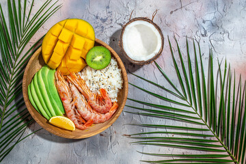 Hawaiian cuisine. Poke with shrimp, avocado, rice, mango, kiwi and coconut. Tropical food. Lunch on...