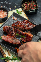 Juicy Beef steak with rosemary and spices. Grilled meat, bbq, barbecue. vertical image. place for text