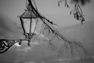 Old lantern against the background of mountains and sky