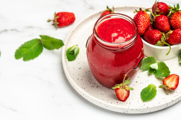 strawberry jam in a jar and fresh berries on white table. banner, menu, recipe place for text