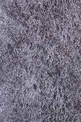Shiny heavily wrinkled metal silver gray foil vertical texture background for design