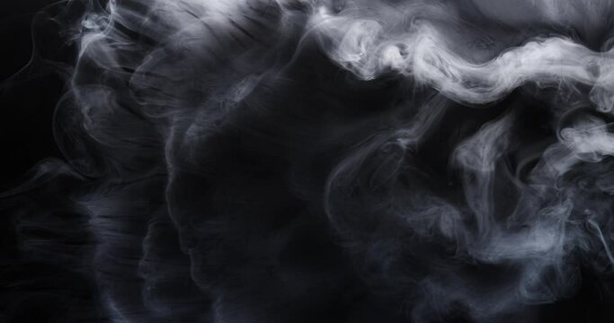 White smoke moves beautifully against a black background. Mockup for your logo. Wide angle horizontal wallpaper or web banner. Slow motion.