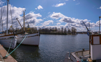 Old fishing and sailing boats at the pier Strandvägen, a sunny spring day in Stockholm