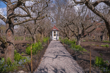 Mansion garden with a 1750s gazebo, rebuilt in a park, a sunny spring day in Stockholm